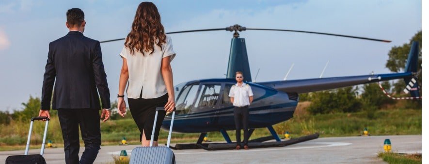 business-couple-walking-to-helicopter-with-pilot-waiting-picture-id1091719242 (1)